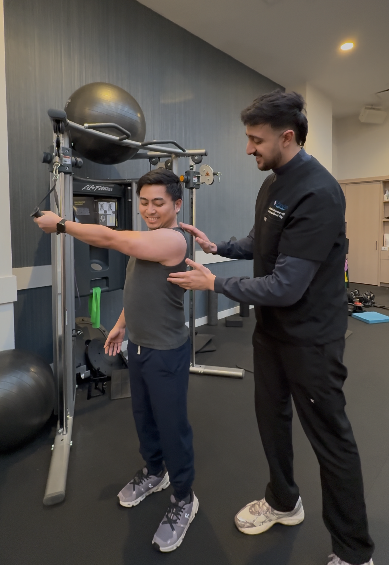 Occupational therapist Daniel guiding a patient through a shoulder exercise