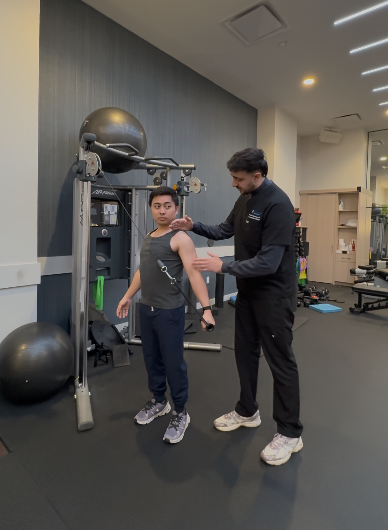 Occupational therapist Daniel assessing a patient during a shoulder exercise
